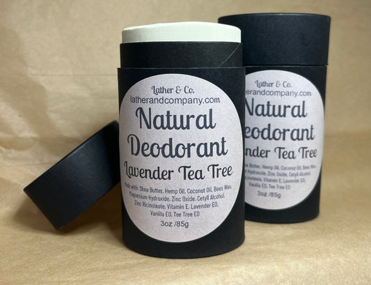 Two cylindrical eco-friendly paperboard deodorant tubes with black lids. The labels indicate the scent is either Lavender Tea Tree or Refreshing Citrus, and the brand is Lather & Co.