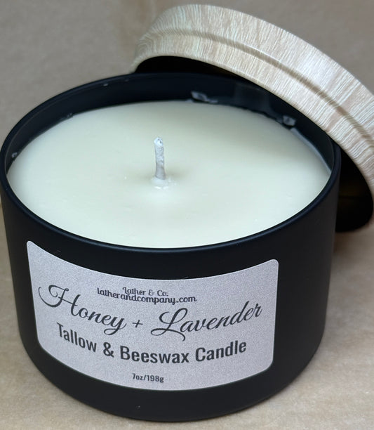 Honey + Lavender candle in a black container with a label on a neutral background