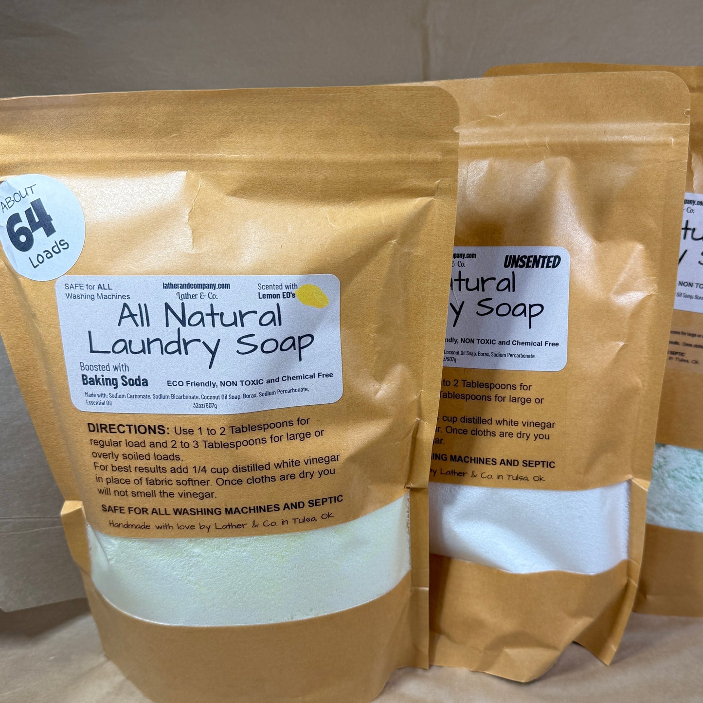 Three packages of all natural laundry soap on a neutral background