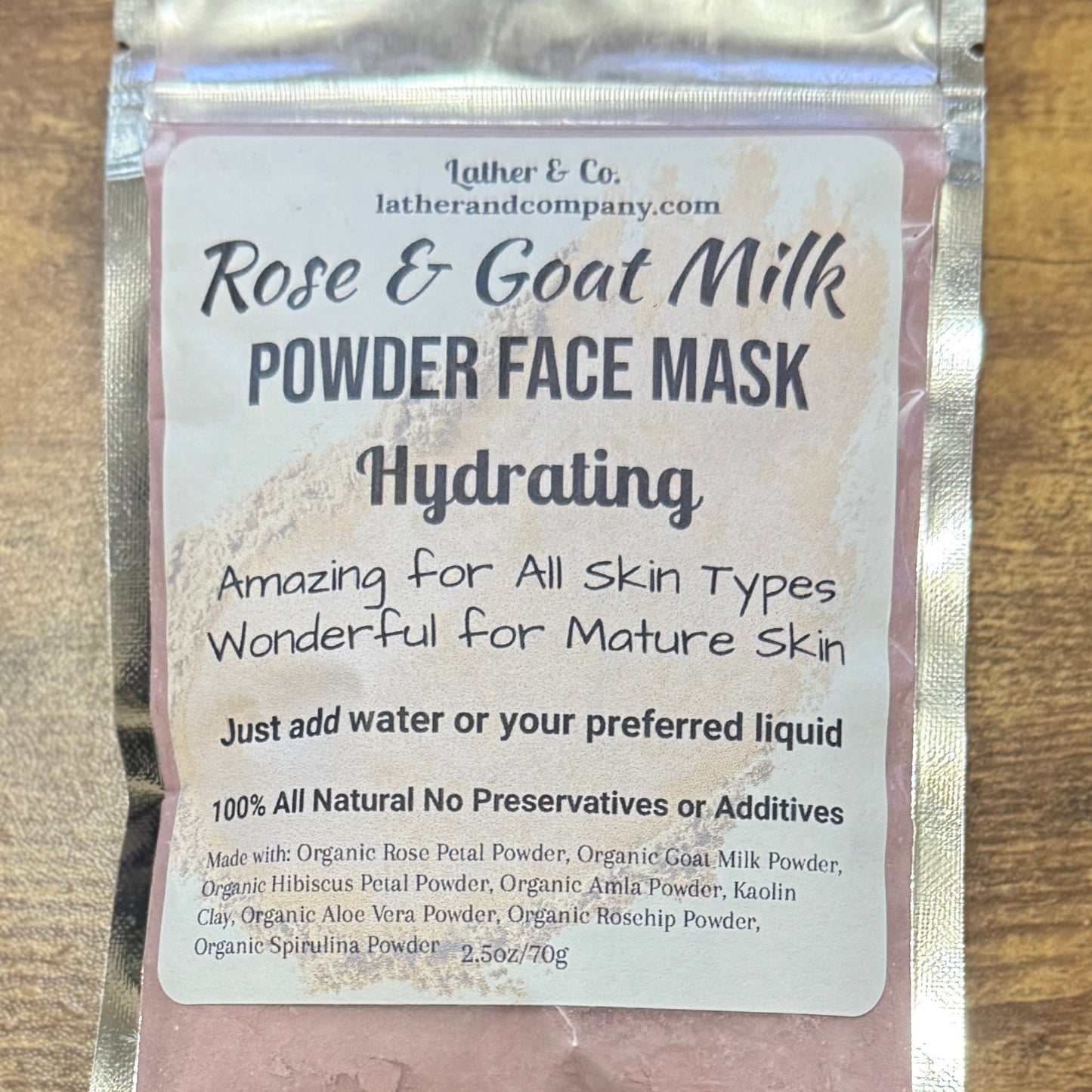 Rose & Goat Milk Powder Face Mask packaging on a wooden surface