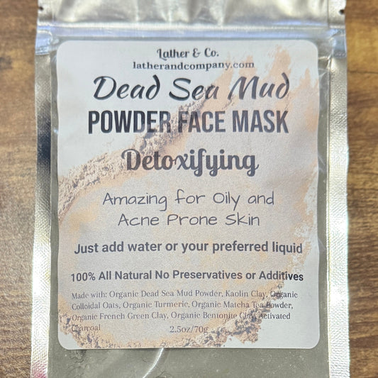 Dead Sea Mud Powder Face Mask packaging with text on a wooden surface