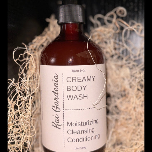 Bottle of creamy body wash with a label on a textured background
