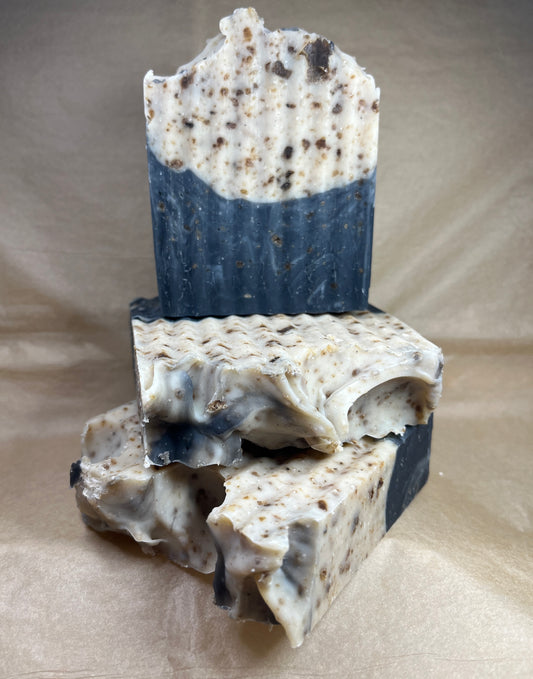 Three pieces of layered soap on a brown background