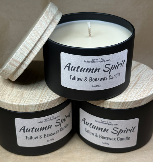 Three 'Autumn Spirit' tallow and beeswax candles stacked on a wooden surface.