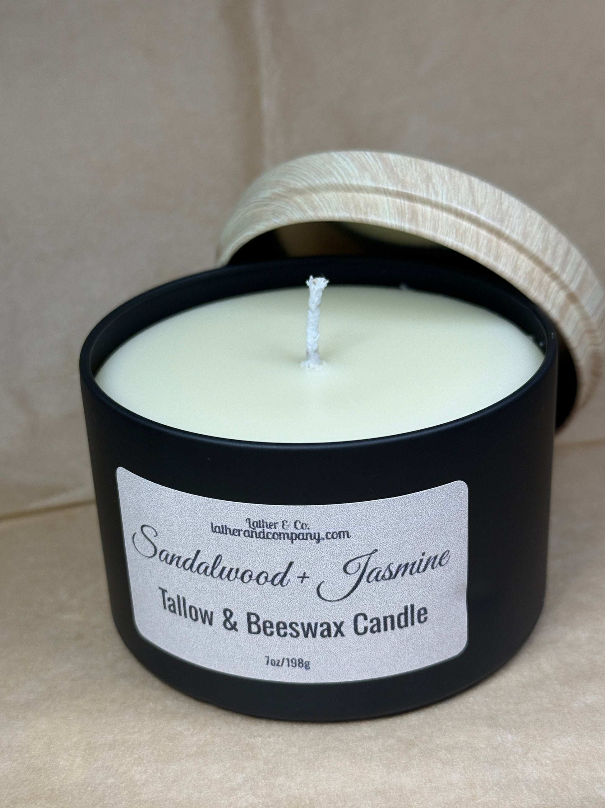 Candle with a label on a beige surface