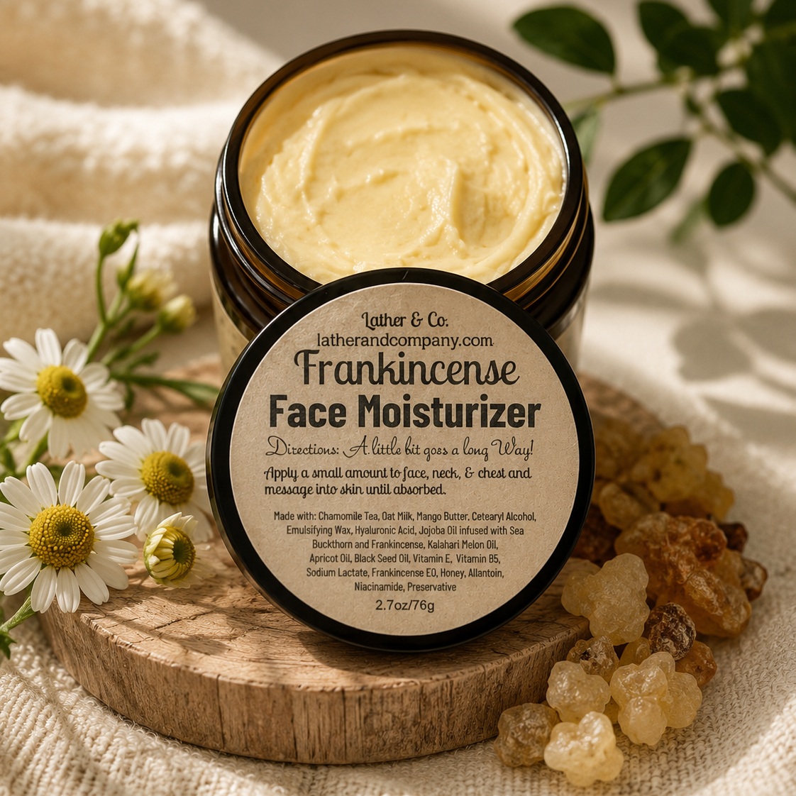 An open jar of Lather & Co. Frankincense Face Moisturizer sits on a wooden tray with its label facing forward.