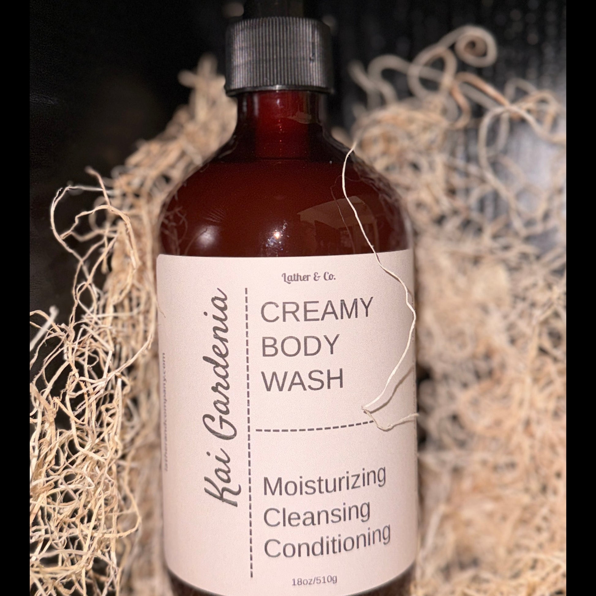 Bottle of creamy body wash with a label on a textured background